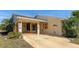 Covered carport featuring dolphin paintings and decorated with pelican and seashell art at 303 Grayston Pl # C133, Sun City Center, FL 33573