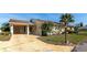 Attractive single-story home with carport, featuring a well-kept lawn and lush landscaping at 303 Grayston Pl # C133, Sun City Center, FL 33573