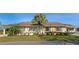 Charming single-story home featuring a well-maintained lawn and a mature palm tree at 303 Grayston Pl # C133, Sun City Center, FL 33573