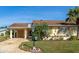 Inviting single-story home with a well-manicured lawn, complemented by a charming garden at 303 Grayston Pl # C133, Sun City Center, FL 33573
