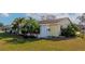 Single-story home with well-maintained lawn, lush landscaping, and a sunny exterior at 303 Grayston Pl # C133, Sun City Center, FL 33573