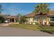 Well-maintained single story home with a carport, a manicured lawn, and mature landscaping at 303 Grayston Pl # C133, Sun City Center, FL 33573