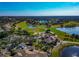 Aerial view of a golf course with manicured greens, water hazards, palm trees, and residential community at 303 Grayston Pl # C133, Sun City Center, FL 33573