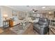 Bright and airy living room featuring hardwood floors, neutral tones, and comfortable seating at 303 Grayston Pl # C133, Sun City Center, FL 33573
