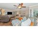 Comfortable living room featuring stylish coastal decor, hardwood floors, and a ceiling fan at 303 Grayston Pl # C133, Sun City Center, FL 33573