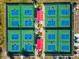Overhead view of pickleball courts bustling with players in a bright and active community at 303 Grayston Pl # C133, Sun City Center, FL 33573