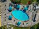 Overhead view of a community pool surrounded by lounge chairs and umbrellas at 303 Grayston Pl # C133, Sun City Center, FL 33573