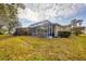 The private backyard features a screened in patio, exterior building and expansive grassy area at 308 28Th W St, Palmetto, FL 34221
