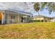 The private backyard features a screened in patio, exterior building and expansive grassy area at 308 28Th W St, Palmetto, FL 34221