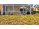 The private backyard features a screened in patio, exterior building and expansive grassy area at 308 28Th W St, Palmetto, FL 34221
