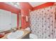 Well-lit bathroom featuring vanity, toilet, and themed shower curtain at 308 28Th W St, Palmetto, FL 34221