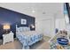 Comfortable bedroom with a bright accent wall, cozy decor, and closet for storage at 308 28Th W St, Palmetto, FL 34221