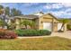 Charming home featuring a two-car garage, well-maintained landscaping, and a welcoming facade at 308 28Th W St, Palmetto, FL 34221