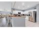 Modern kitchen featuring stainless steel appliances, sleek white cabinetry, and an adjoining living space at 308 28Th W St, Palmetto, FL 34221