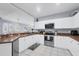 Bright kitchen featuring white cabinetry, stainless steel appliances, and durable countertops at 308 28Th W St, Palmetto, FL 34221