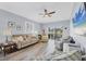 Bright living room with hardwood floors, a ceiling fan, and a sliding glass door to the backyard at 308 28Th W St, Palmetto, FL 34221