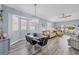 Open-plan living area with connecting dining room, chandelier, and backyard view at 308 28Th W St, Palmetto, FL 34221
