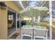 Relaxing screened patio features a dining table with an umbrella, grill and access to the main living area at 308 28Th W St, Palmetto, FL 34221