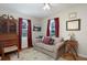 Cozy bedroom featuring a comfortable couch, hardwood floors, and natural light at 311 E Ross Ave, Tampa, FL 33602