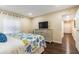 Comfortable bedroom featuring queen bed, coastal decor, and wood flooring at 3231 Beneva Rd # 101, Sarasota, FL 34232