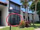A bright and airy exterior view showcasing the well-maintained facade of this multi-unit residential building with lush greenery at 3231 Beneva Rd # 101, Sarasota, FL 34232