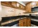 Beautiful kitchen with wood cabinets, black counters, stainless steel appliances and updated fixtures at 3231 Beneva Rd # 101, Sarasota, FL 34232