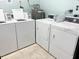 Functional laundry room with coin operated washing machines and dryers at 3231 Beneva Rd # 101, Sarasota, FL 34232