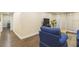 A wide view of an inviting living room features comfortable seating and a seamless transition into the adjacent hallway and kitchen at 3231 Beneva Rd # 101, Sarasota, FL 34232