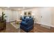 Comfortable living room with stylish decor, a cozy sofa, and plenty of natural light from the sheer-curtained sliding glass doors at 3231 Beneva Rd # 101, Sarasota, FL 34232