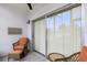 Cozy screened patio with tile floors, a chair and a table for relaxing outdoors at 3231 Beneva Rd # 101, Sarasota, FL 34232