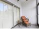 Comfortable screened patio showcasing seating with orange cushions and views of the surrounding greenery at 3231 Beneva Rd # 101, Sarasota, FL 34232