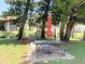 Serene picnic area featuring tables, an umbrella, and pond at 3231 Beneva Rd # 101, Sarasota, FL 34232