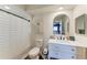 Bright bathroom with a walk-in shower, white vanity, and stylish decor at 3285 Datura Rd, Venice, FL 34293