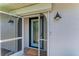 Close-up of a front door with a decorative screen door and exterior lighting at 3285 Datura Rd, Venice, FL 34293