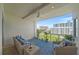 This balcony features comfortable seating, a ceiling fan, and views of the surrounding cityscape at 332 Cocoanut Ave # 406, Sarasota, FL 34236