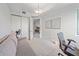 This bedroom includes a gray sofa, closet, minimalist decor, and an open doorway to other living spaces at 332 Cocoanut Ave # 406, Sarasota, FL 34236