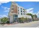 Modern, white exterior with balconies, large windows, and street view, plus a mix of wood and concrete at 332 Cocoanut Ave # 406, Sarasota, FL 34236