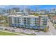 A modern condo building boasts multiple balconies, blue awnings, and street parking at 332 Cocoanut Ave # 406, Sarasota, FL 34236