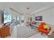 Bright living room features a modern chandelier, comfortable seating, and sliding glass doors to the outside at 332 Cocoanut Ave # 406, Sarasota, FL 34236