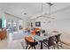Modern living area featuring unique lighting, glass dining table, and colorful decor with access to the balcony at 332 Cocoanut Ave # 406, Sarasota, FL 34236