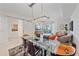 Stylish living room features modern lighting, glass dining table, open floorplan, and balcony access at 332 Cocoanut Ave # 406, Sarasota, FL 34236