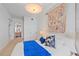 Comfortable main bedroom featuring bright blue accents, a decorative wall hanging, and a chic overhead light at 332 Cocoanut Ave # 406, Sarasota, FL 34236
