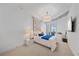 Serene main bedroom with plush bedding, a decorative wall hanging, and a sliding door to a balcony at 332 Cocoanut Ave # 406, Sarasota, FL 34236
