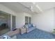 The covered patio offers a cozy seating area with a wicker sofa and a ceiling fan for comfort at 332 Cocoanut Ave # 406, Sarasota, FL 34236