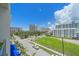 Daytime street view showcases palm trees, clear blue sky, and various buildings at 332 Cocoanut Ave # 406, Sarasota, FL 34236