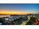 Twilight aerial panorama of the harbor, featuring yachts, cityscape lights, and a picturesque sunset over the water at 340 S Palm Ave # 152, Sarasota, FL 34236