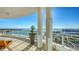 Wide balcony featuring glass railings and a sweeping view of the bay with boats, city and a bright sunny sky at 340 S Palm Ave # 152, Sarasota, FL 34236