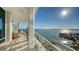 Curved balcony with glass railings boasting stunning views of the water, boats, and a clear blue sky at 340 S Palm Ave # 152, Sarasota, FL 34236
