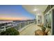 An expansive, curved balcony with seating provides exceptional city and bay views at dusk, showcasing a luxury outdoor space at 340 S Palm Ave # 152, Sarasota, FL 34236