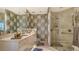 Bathroom showcasing a glass enclosed shower, vanity, and decorative wallpaper at 340 S Palm Ave # 152, Sarasota, FL 34236